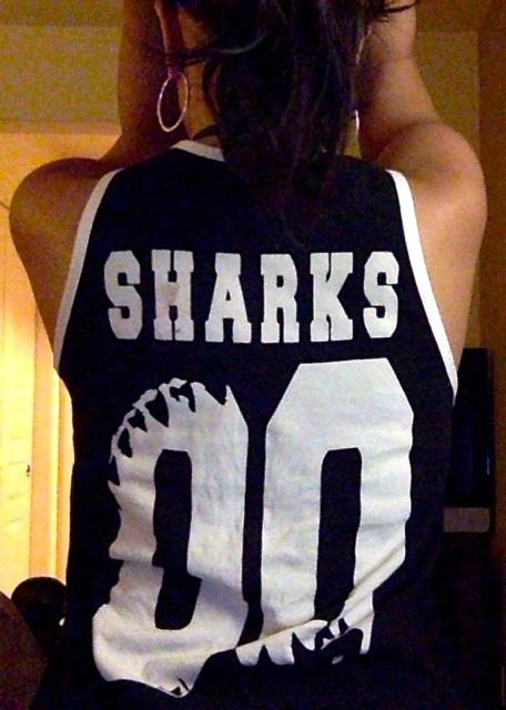 Sports jersey style tank top with great white shark jaws on the front and jersey number and the word 
