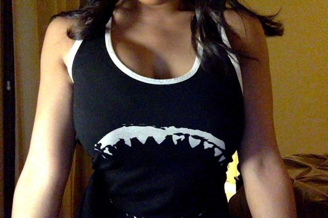 Ht woman with big tits in shark teeth tank top. Sports jersey style tank top with great white shark jaws on the front and jersey number and the word 